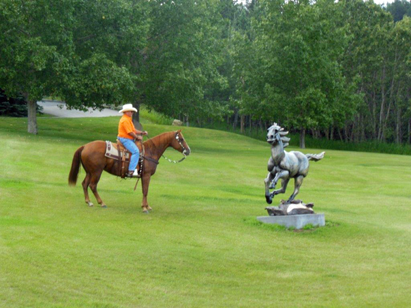 John on horse next to sculpture