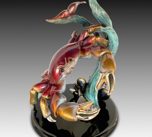 Iridescent ceramic crab sculpture with kelp